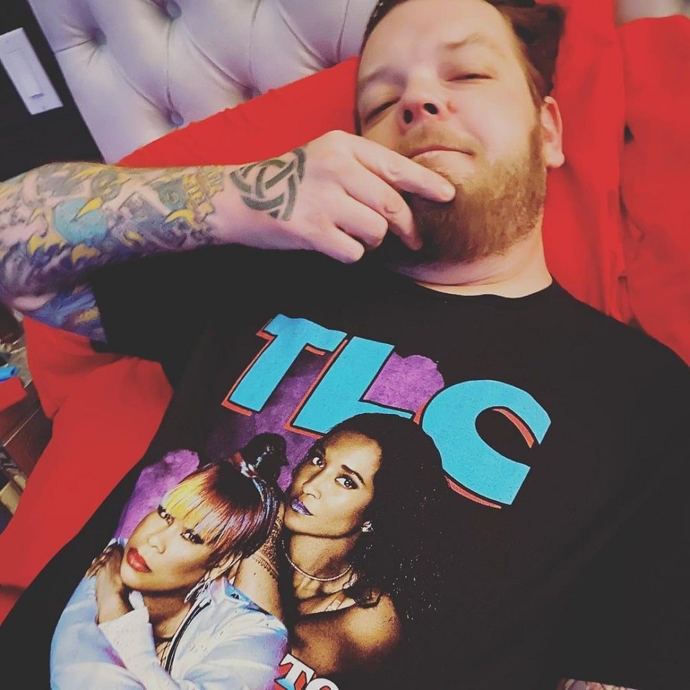 Image of Corey Harrison lying on a couch.